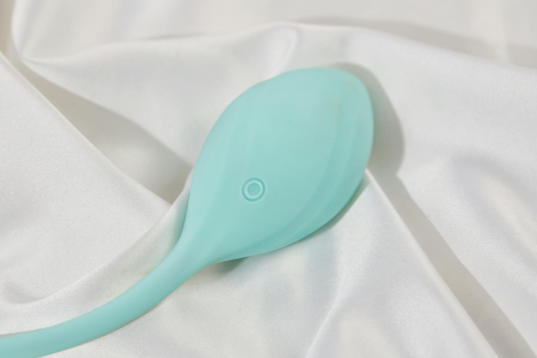 Woman holding different colored vibrators, considering her options during treatment changes