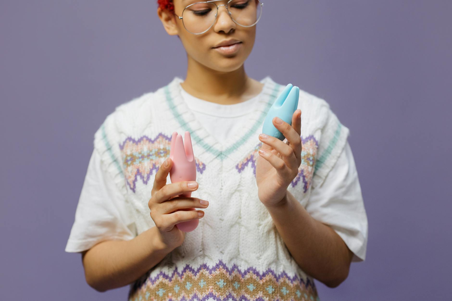 Woman holding colorful lemon clitoral vibrators and intimate wellness products for pelvic floor recovery